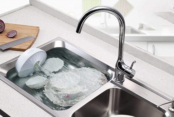 portable dishwasher cleaning dishes in a sink