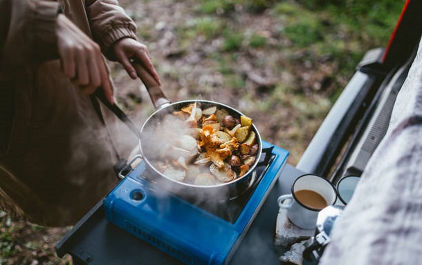 Making food on camping hot plate