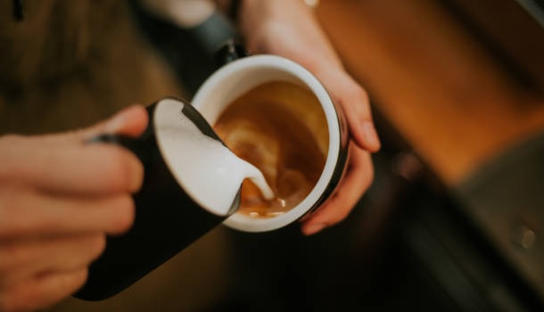 Pouring Milk Into Espresso