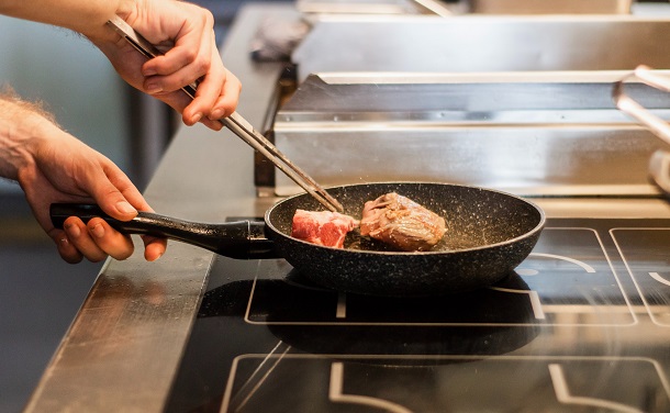 chef searing steak