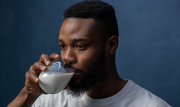 man drinking almond milk